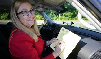 Republican gubernatorial candidate State Sen. Amanda Chase, fills out her ballot during a drive through GOP Convention vote in Chesterfield, Va., Saturday, May 8, 2021. (AP Photo/Steve Helber)