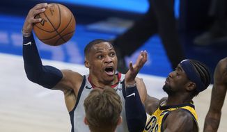 Washington Wizards&#39; Russell Westbrook goes to the basket against Indiana Pacers&#39; Caris LeVert (22) during the first half of an NBA basketball game Saturday, May 8, 2021, in Indianapolis. (AP Photo/Darron Cummings)