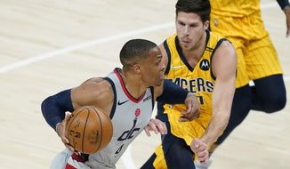 Washington Wizards&#39; Russell Westbrook (4) goes to the basket against Indiana Pacers&#39; Doug McDermott (20) during the first half of an NBA basketball game Saturday, May 8, 2021, in Indianapolis. (AP Photo/Darron Cummings)