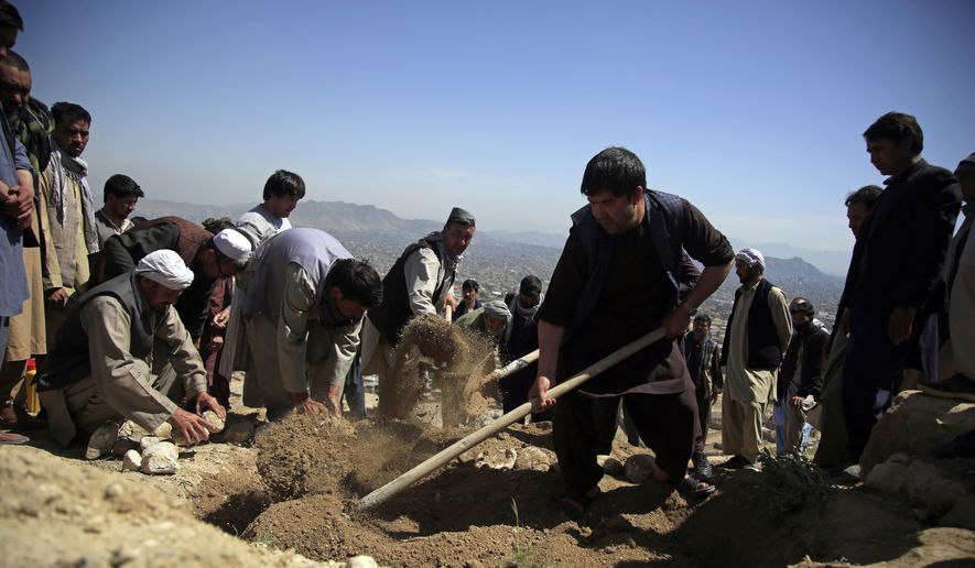 Afghan men bury a victim of deadly bombings on Saturday near a school, west of Kabul, Afghanistan, Sunday, May 9, 2021. The Interior Ministry said Sunday the death toll in the horrific bombing at the entrance to a girls&#39; school in the Afghan capital has soared to some 50 people, many of them pupils between 11 and 15 years old, and the number of wounded in Saturday&#39;s attack has also climbed to more than 100. (AP Photo/Mariam Zuhaib)