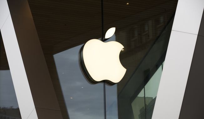 In this Saturday, March 14, 2020, file photo, an Apple logo adorns the facade of the downtown Brooklyn Apple store in New York. (AP Photo/Kathy Willens, File)