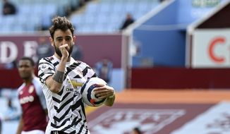 Manchester United&#39;s Bruno Fernandes celebrates after scoring his side&#39;s opening goal from penalty during the English Premier League soccer match between Aston Villa and Manchester United at Villa Park in Birmingham, England, Sunday, May 9, 2021. (Shaun Botterill/Pool via AP)