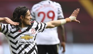 Manchester United&#39;s Edinson Cavani celebrates after scoring his side&#39;s third goal during the English Premier League soccer match between Aston Villa and Manchester United at Villa Park in Birmingham, England, Sunday, May 9, 2021. (Shaun Botterill/Pool via AP)