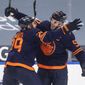 Edmonton Oilers&#39; Connor McDavid (97) and Leon Draisaitl (29) celebrates after McDavid&#39;s 100th point of the season, during the second period of an NHL hockey game against the Vancouver Canucks on Saturday, May 8, 2021, in Edmonton, Alberta. (Jason Franson/The Canadian Press via AP)