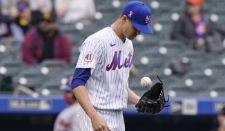 New York Mets starting pitcher Jacob deGrom tosses the ball during the fifth inning of a baseball game against the Arizona Diamondbacks, Sunday, May 9, 2021, in New York. deGrom left the game in the sixth inning after throwing only two warmup pitches. (AP Photo/Kathy Willens)