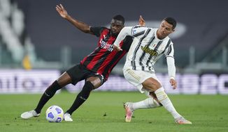 Inter Milan&#39;s Fikayo Tomori, left, competes for the ball against Juventus&#39; Cristiano Ronaldo during the Italian Serie A soccer match between Juventus and Milan, at the Juventus Stadium in Turin, Italy, Sunday, May 9, 2021. (Spada/LaPresse via AP)