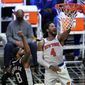 New York Knicks guard Derrick Rose (4) scores past Los Angeles Clippers forward Marcus Morris Sr. (8) during the first half of an NBA basketball game Sunday, May 9, 2021, in Los Angeles. (AP Photo/Marcio Jose Sanchez)