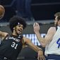 Cleveland Cavaliers&#x27; Jarrett Allen (31) tries to pass the ball against Dallas Mavericks&#x27; Nicolo Melli (44) in the first half of an NBA basketball game, Sunday, May 9, 2021, in Cleveland. (AP Photo/Tony Dejak)