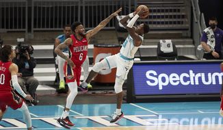 Charlotte Hornets guard Terry Rozier (3) shoots over New Orleans Pelicans guard Nickeil Alexander-Walker (6) during the first half of an NBA basketball game Sunday, May 9, 2021, in Charlotte, N.C. (AP Photo/Brian Westerholt)