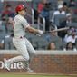 Philadelphia Phillies&#39; J.T. Realmuto watches his double off Atlanta Braves pitcher Ian Anderson in the first inning of a baseball game Saturday, May 8, 2021, in Atlanta. (AP Photo/Ben Margot)
