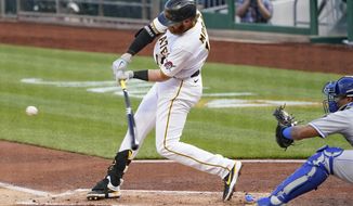 Pittsburgh Pirates&#39; Colin Moran hits a single to drive in Bryan Reynolds from second in the first inning of a baseball game against the Kansas City Royals, Tuesday, April 27, 2021, in Pittsburgh. (AP Photo/Keith Srakocic)