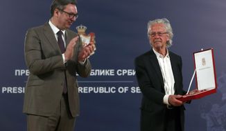 Austrian author Peter Handke, right, receives the Order of the Karadjordje&#39;s Star from Serbian President Aleksandar Vucic in Belgrade, Serbia, Sunday, May 9, 2021. Serbia has decorated Austrian Nobel literature laureate Peter Handke, who is known for his apologist views over Serb war crimes during the 1990s&#39; wars in the Balkans. (AP Photo/Darko Vojinovic)