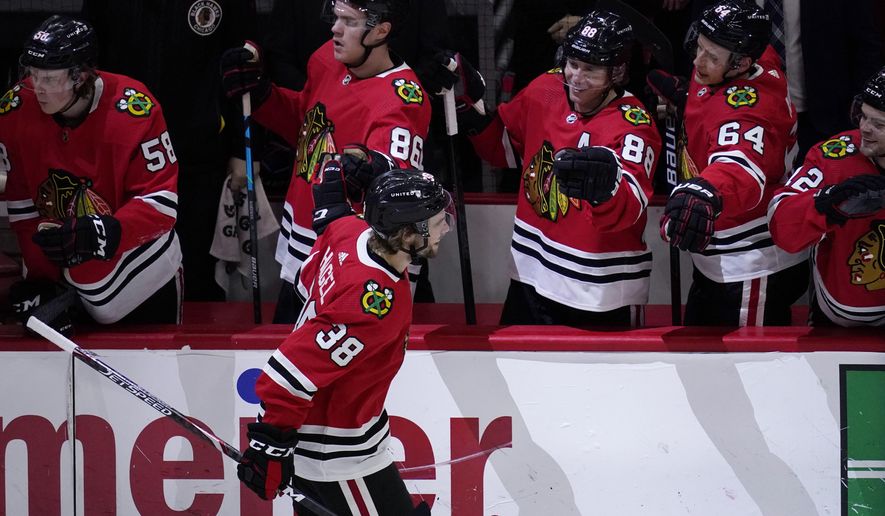 Chicago Blackhawks left wing Brandon Hagel (38) celebrates with teammates after scoring during the first period of the team&#39;s NHL hockey game against the Dallas Stars in Chicago, Sunday, May 9, 2021. (AP Photo/Nam Y. Huh)