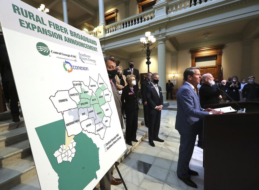 FILE - In this Monday, Feb 8, 2021 file photo, Gov. Brian Kemp speaks during a news conference about expanding rural internet access in the state, at the Georgia Capitol in Atlanta. The federal American Rescue Plan, comes on top of $150 billion the federal government sent directly to states and local governments in 2020. This year's law cites infrastructure for water, sewer and broadband internet as allowable uses. (Curtis Compton/Atlanta Journal-Constitution via AP)
