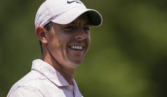 Rory McIlroy smiles after his putt on the third hole during the fourth round of the Wells Fargo Championship golf tournament at Quail Hollow on Sunday, May 9, 2021, in Charlotte, N.C. (AP Photo/Jacob Kupferman)