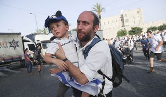 Israelis run to shelters as air attack sirens goes off during a Jerusalem Day march, in Jerusalem, Monday, May 10, 2021. Explosions have been heard in Jerusalem after air raid sirens sounded. The sirens came Monday, shortly after the Hamas militant group in Gaza had set a deadline for Israel to remove its security forces from the Al-Aqsa Mosque compound. (AP Photo/Ariel Schalit)