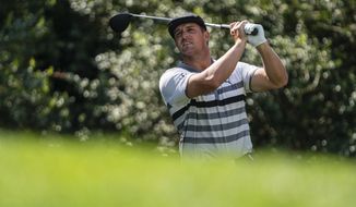 Bryson DeChambeau watches his tee shot on the 14th hole during the third round of the Wells Fargo Championship golf tournament at Quail Hollow on Saturday, May 8, 2021, in Charlotte, N.C. (AP Photo/Jacob Kupferman)