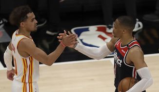Washington Wizards&#39; Russell Westbrook, right, is congratulated by Atlanta Hawks&#39; Trae Young after an NBA basketball game Monday, May 10, 2021, in Atlanta. Westbrook recorded his 182nd career triple-double, passing Oscar Robertson for the most in NBA history. (AP Photo/Ben Margot)