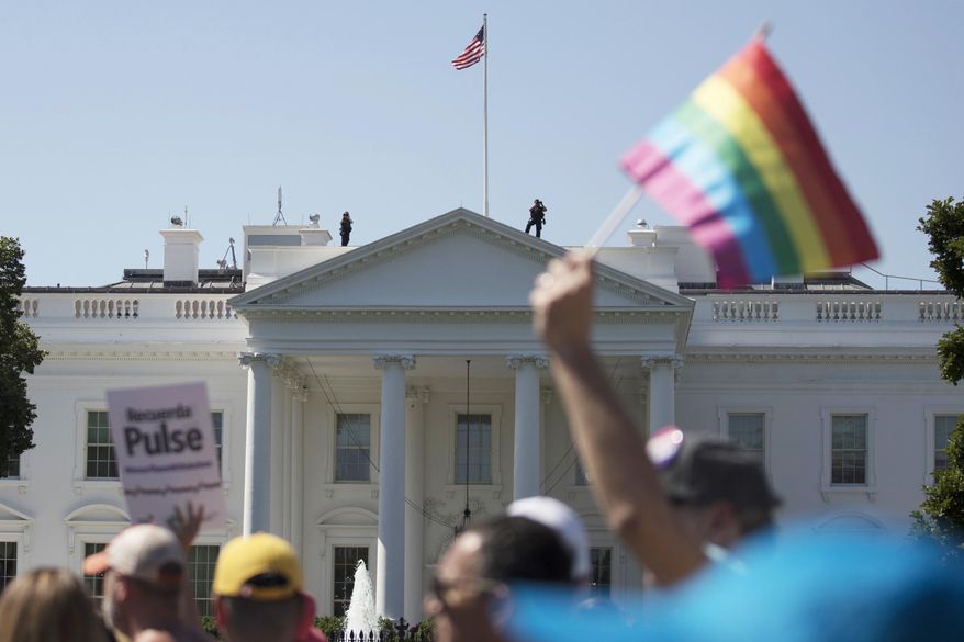 In this Sunday, June 11, 2017, file photo, Equality March for Unity and Pride participants march past the White House in Washington. (AP Photo/Carolyn Kaster)