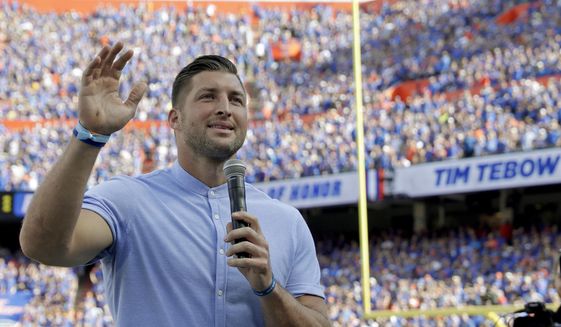 Former Florida football player Tim Tebow speaks to fans after he was inducted in the Ring of Honor at Florida Field during the first half of an NCAA college football game against LSU in Gainesville, Fla., in this Saturday, Oct. 6, 2018, file photo. Tebow and Urban Meyer are apparently getting back together, this time in the NFL. The former Florida star and 2007 Heisman Trophy-winning quarterback is expected to team up with his college coach by signing a one-year contract to play for the Jacksonville Jaguars, the NFL Network reported Monday, May 10, 2021. (AP Photo/John Raoux, File) **FILE**