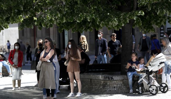 People wait in line in front of a shop in Prague, Czech Republic, Monday, May 10, 2021. The Czech Republic is massively relaxing its coronavirus restrictions as the hard-hit nation pay respect to nearly 30,000 dead. Monday&#x27;s wave of easing came after the new infections fell to the levels unseen from August when the government failed to react in time to an opposite trend, the growing numbers of infected which later contributed to record numbers of deaths. (AP Photo/Petr David Josek)