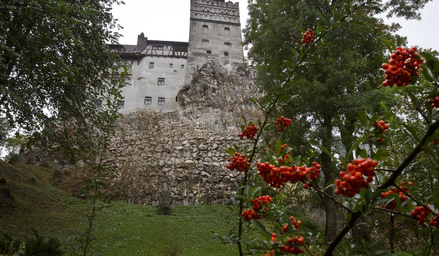 FILE - In this Saturday, Oct. 8, 2011 file picture, the Gothic Bran Castle, better known as Dracula Castle, is seen on a rainy day in Bran, in Romania&#39;s central Transylvania region. Romanian authorities have set up a COVID-19 vaccination center in a medieval building in Bran, not far from the castle, as a means to encourage people to vaccinate and also to boost tourism which has decreased in the area as a result of the pandemic. (AP Photo/Vadim Ghirda, File)