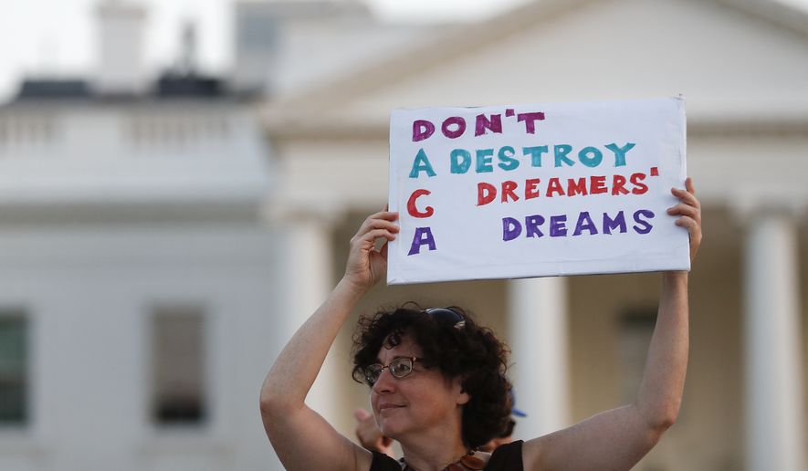 Julia Paley, of Arlington, Va., with the DMV Sanctuary Congregation Network, holds up a sign that reads &quot;DACA Don&#x27;t Destroy Dreamers Dreams&quot; during a rally supporting Deferred Action for Childhood Arrivals, or DACA, outside the White House, in Washington, Monday, Sept. 4, 2017. (AP Photo/Carolyn Kaster) ** FILE **