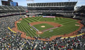 The Los Angeles Angels and Oakland Athletics stand for the national anthem at the Oakland Coliseum prior to an opening day baseball game in Oakland, Calif., in this Thursday, March 29, 2018, file photo.Major League Baseball instructed the Athletics to explore relocation options as the team tries to secure a new ballpark it hopes will keep the club in Oakland in the long term. MLB released a statement Tuesday, May 11, 2021, expressing its longtime concern that the current Coliseum site is not a viable option for the future vision of baseball. (AP Photo/Ben Margot, File) **FILE**