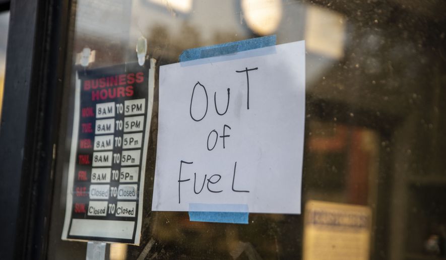A sign reading &quot;Out of Fuel&quot; is taped to the window at an Exxon Gas Station on Boonsboro Road in Lynchburg, Va., Tuesday, May 11, 2021. More than 1,000 gas stations in the Southeast reported running out of fuel, primarily because of what analysts say is unwarranted panic-buying among drivers, as the shutdown of a major pipeline by hackers entered its fifth day. In response, Virginia Gov. Ralph Northam declared a state of emergency. (Kendall Warner/The News &amp; Advance via AP)