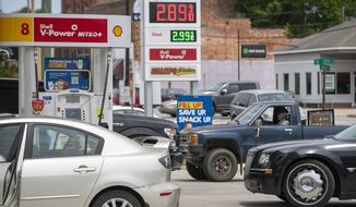 Customers wait in line to purchase fuel at the Duck-Thru in Scotland Neck, N.C., on Tuesday, May 11, 2021. The station was doing a brisk business on Tuesday as news of the cyberattack on the Colonial Pipeline spread fear of a gas shortage in rural North Carolina. (Robert Willett/The News &amp; Observer via AP)