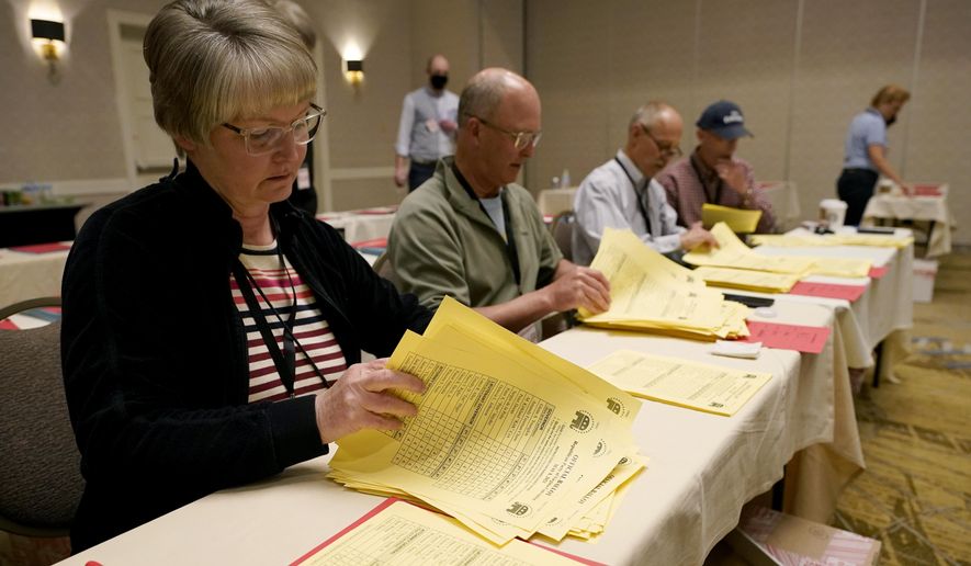 Republican convention workers count ballots in Virginia's lieutenant governor race in Richmond, Va., Tuesday, May 11, 2021. More than 30,000 delegates cast ballots Saturday at what the Republican Party of Virginia is calling an “unassembled convention” to choose their nominees for governor, lieutenant governor and attorney general. (AP Photo/Steve Helber)