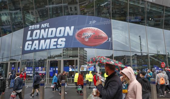 NFL football fans arrive at Tottenham Hotspur Stadium to watch an NFL football game between the Tampa Bay Buccaneers and the Carolina Panthers in London, in this Sunday, Oct. 13, 2019, file photo. The NFL is returning to London in October. The first game in London since the coronavirus pandemic will be played on Oct. 10 as the Atlanta Falcons face the New York Jets. A week later, the Jacksonville Jaguars meet the Miami Dolphins. Both games will be played at the stadium of Premier League soccer team Tottenham. The Falcons and the Jaguars will be the home teams. (AP Photo/Alastair Grant, File) **FILE**