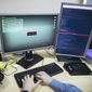 An employee of Global Cyber Security Company Group-IB develops a computer code in an office in Moscow, Russia, Wednesday, Oct. 25, 2017. (AP Photo/Pavel Golovkin) ** FILE **