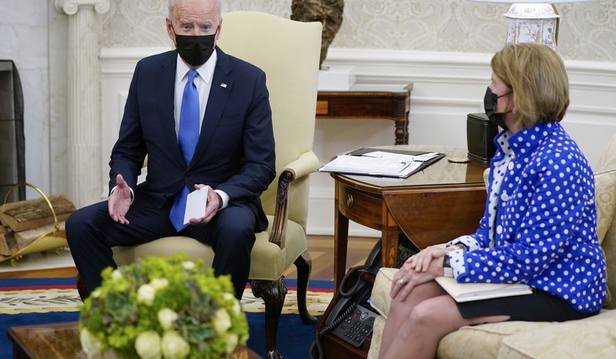 Sen. Shelley Moore Capito, R-W.Va., right, listens as President Joe Biden speaks during a meeting with Republican Senators in the Oval Office of the White House, Thursday, May 13, 2021, in Washington. (AP Photo/Evan Vucci)
