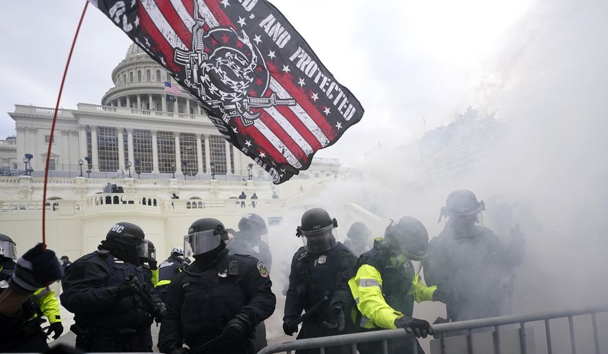 In this Jan. 6, 2021, file photo, police try to hold off supporters of then-President Donald Trump who tried to break through a police barrier, at the U.S. Capitol in Washington. (AP Photo/Julio Cortez, File)
