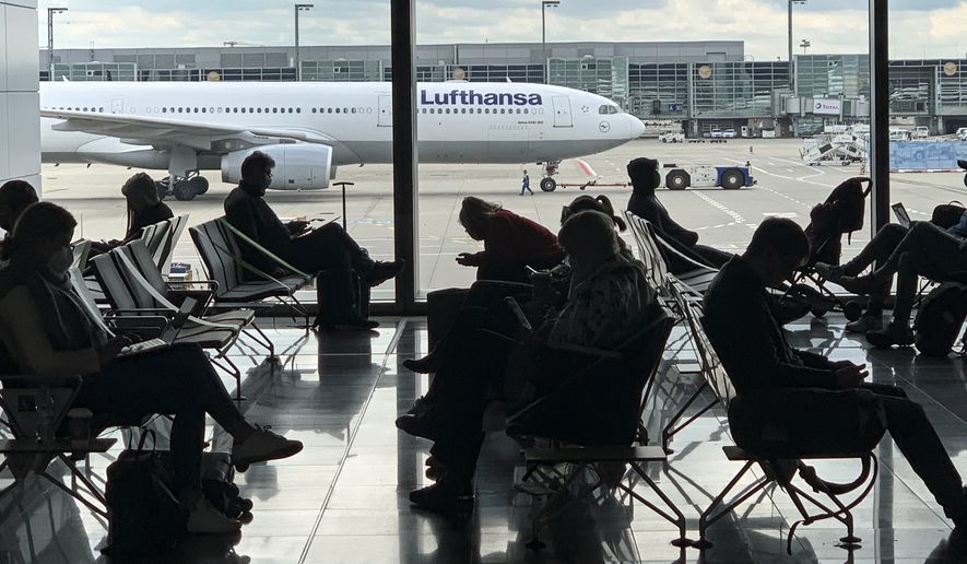 Passengers wait for their Lufthansa flight at the airport in Frankfurt, Germany, Saturday, May 15, 2021. (AP Photo/Martin Meissner) ** FILE **