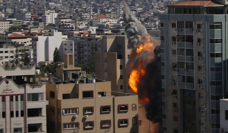 An Israeli airstrike hits the high-rise building housing The Associated Press&#39; offices in Gaza City, Saturday, May 15, 2021. The airstrike Saturday came roughly an hour after the Israeli military ordered people to evacuate the building. The building housed The Associated Press, Al-Jazeera and a number of offices and apartment. (AP Photo/Hatem Moussa)