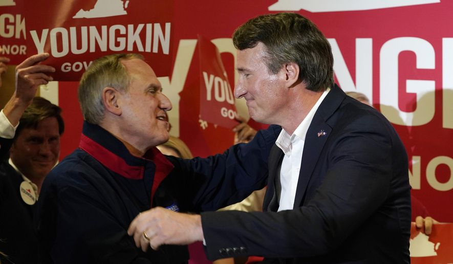 Republican gubernatorial candidate, Glenn Youngkin, right, hugs Virginia Republican party chairman, Rich Anderson, as he arrives for an event in Richmond, Va., Tuesday, May 11, 2021. (AP Photo/Steve Helber) ** FILE **