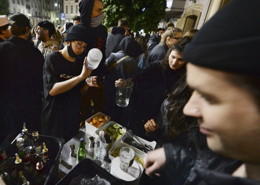 People gather and celebrate as bars, clubs and other establishments reopened in Poland after being closed for seven months, in Warsaw, Poland, Friday, May 14, 2021. (AP Photo/Czarek Sokolowski)