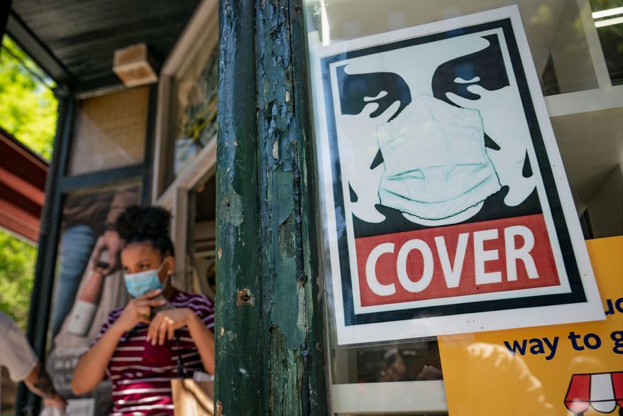 The sight of protective masks in public will start to fade away as totally vaccinated Americans feel safe to go out without them. (Associated Press/File)
