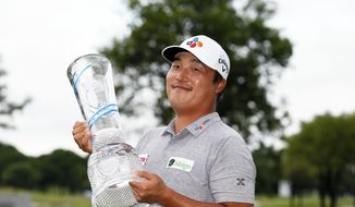 K.H. Lee, of South Korea, holds the Champions Trophy after winning the AT&amp;T Byron Nelson golf tournament in McKinney, Texas, Sunday, May 16, 2021. (AP Photo/Ray Carlin)