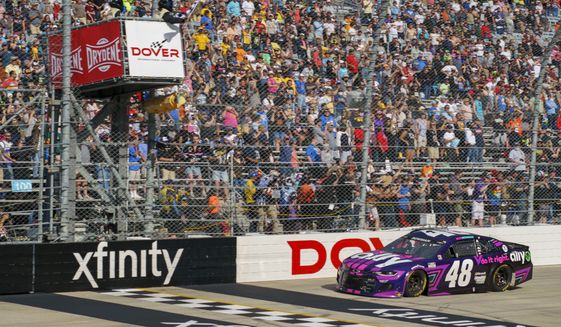 Alex Bowman gets the checker flag as he finishes first during a NASCAR Cup Series auto race at Dover International Speedway, Sunday, May 16, 2021, in Dover, Del. Alex Bowman wins the race. (AP Photo/Chris Szagola)
