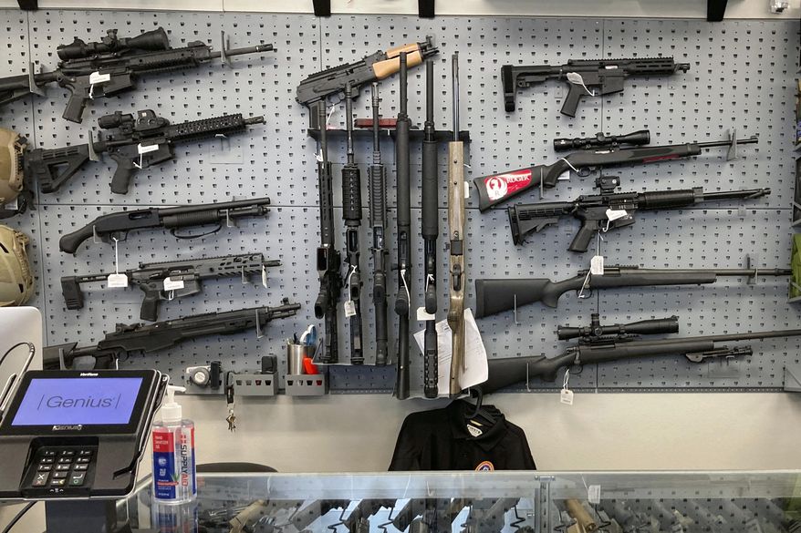 In this Feb. 19, 2021, file photo, firearms are displayed at a gun shop in Salem, Ore. (AP Photo/Andrew Selsky, File)