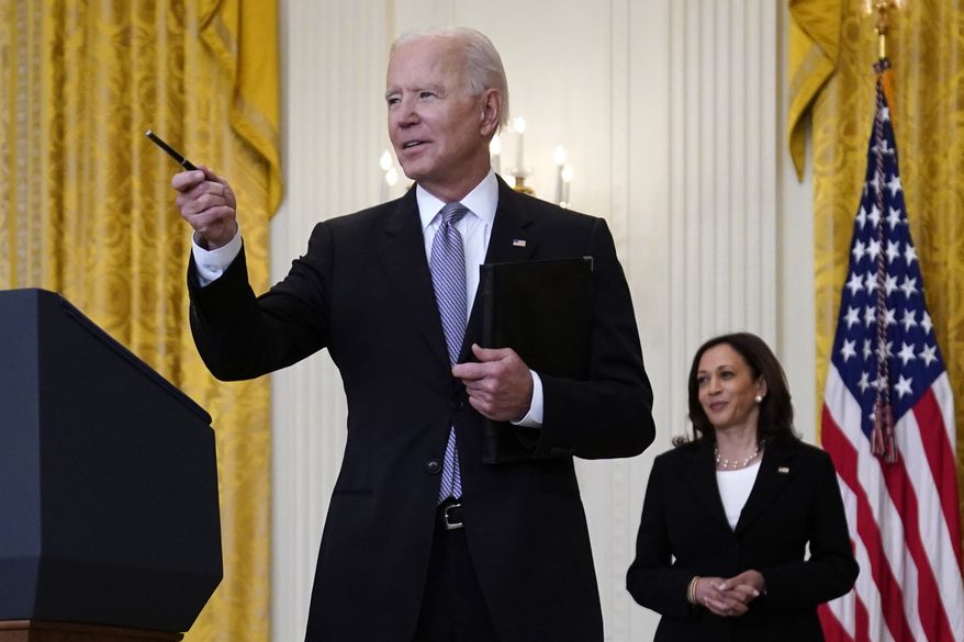 Vice President Kamala Harris watches as President Joe Biden takes a question from a reporter after speaking about distribution of COVID-19 vaccines, in the East Room of the White House, Monday, May 17, 2021, in Washington. (AP Photo/Evan Vucci)