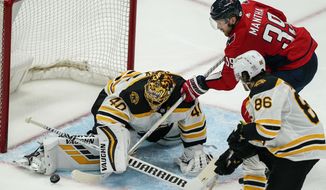Washington Capitals right wing Anthony Mantha (39) cannot get the puck past Boston Bruins goaltender Tuukka Rask (40) with Bruins defenseman Kevan Miller (86) nearby during the third period of Game 2 of an NHL hockey Stanley Cup first-round playoff series Monday, May 17, 2021, in Washington. (AP Photo/Alex Brandon)