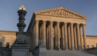 In this Nov. 6, 2020, photo, the Supreme Court is seen at sundown in Washington. (AP Photo/J. Scott Applewhite) ** FILE **