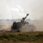 An Israeli artillery unit fires toward targets in the Gaza Strip, at the Israeli-Gaza border, Sunday, May 16, 2021. (AP Photo/Heidi Levine)