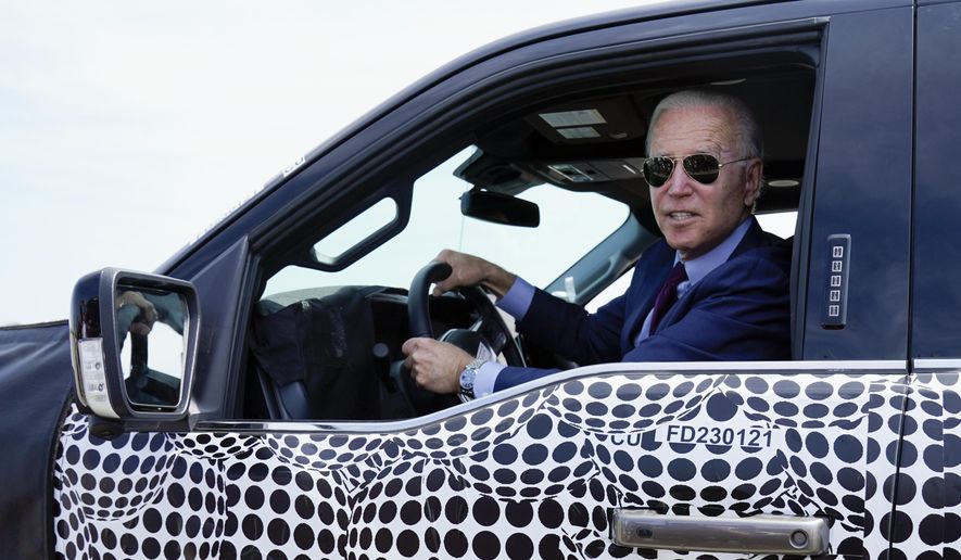 President Joe Biden stops to talk to the media as he drives a Ford F-150 Lightning truck at Ford Dearborn Development Center, Tuesday, May 18, 2021, in Dearborn, Mich. (AP Photo/Evan Vucci) ** FILE **
