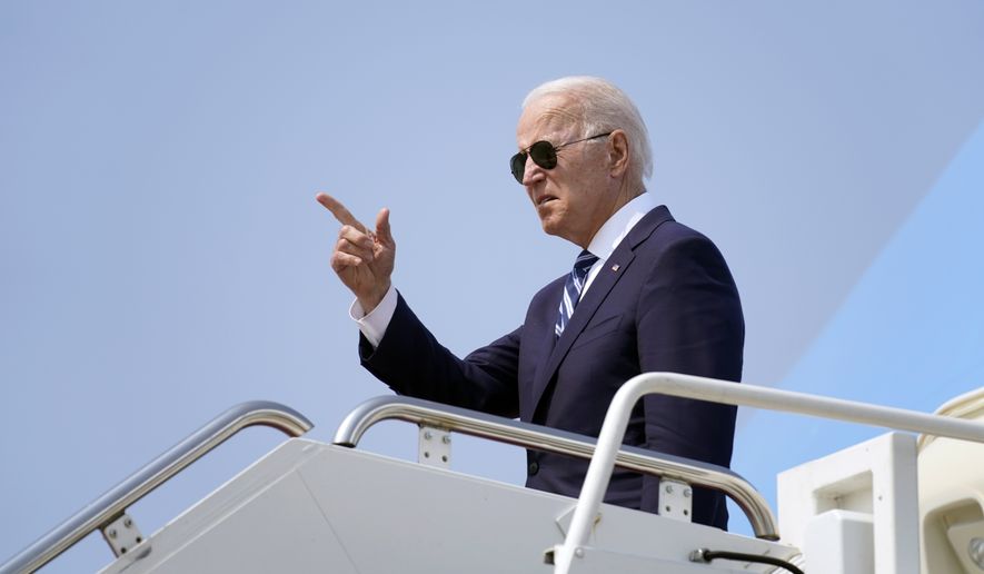 President Joe Biden points before boarding Air Force One at Quonset Point Air National Guard in North Kingstown, R.I., Wednesday, May 19, 2021, to travel back to Washington after attending the commencement for the United States Coast Guard Academy in New London, Conn. (AP Photo/Andrew Harnik)