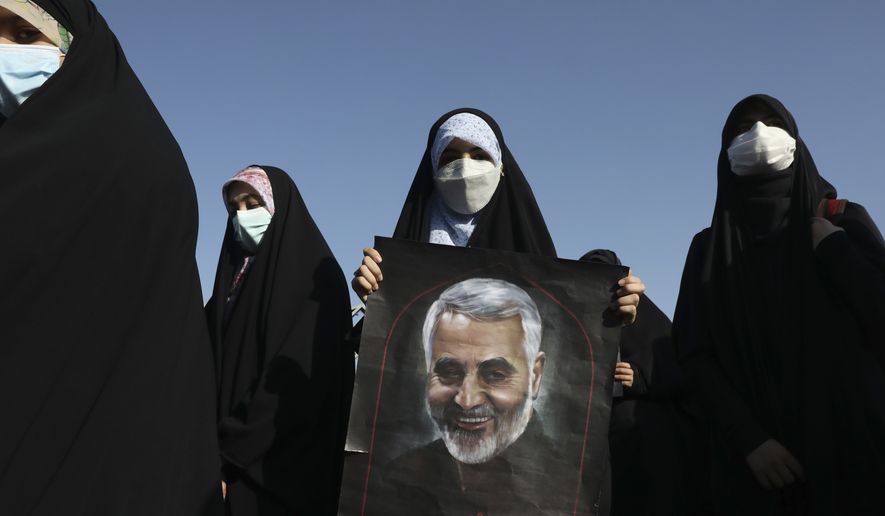 A demonstrator holds a poster of Iranian Revolutionary Guard Gen. Qassem Soleimani, who was killed in Iraq in a U.S. drone attack in early January 2020, in a pro-Palestinians gathering in Tehran, Iran, Wednesday, May 19, 2021. Chief of the powerful Revolutionary Guard Gen. Hossein Salami said in the gathering that Israel has become weaker and the Palestinians have become stronger and more powerful. Iran does not recognize Israel and supports anti-Israeli militant groups like Palestinian Hamas and Lebanon&#39;s Hezbollah. (AP Photo/Vahid Salemi)